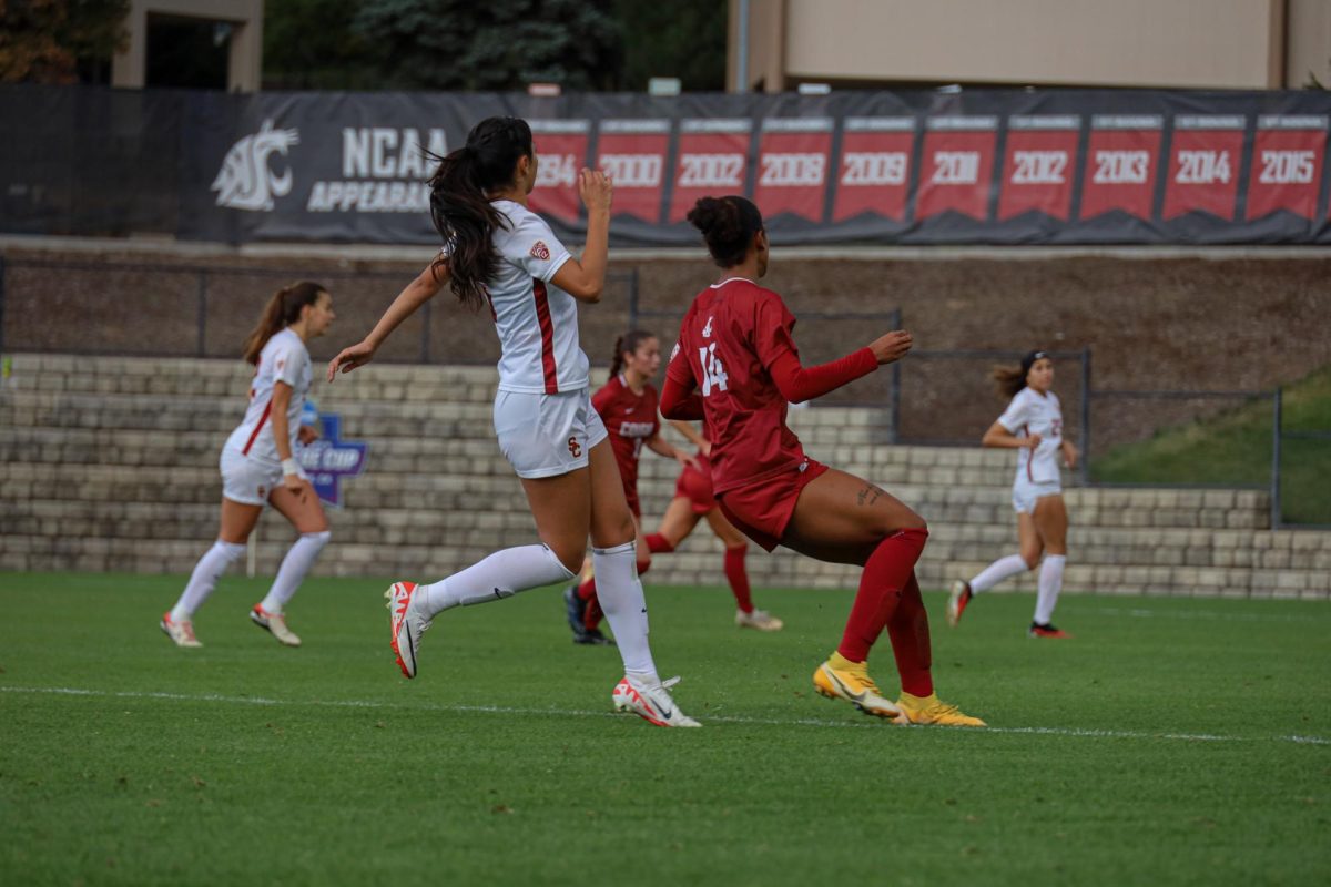 WSU number 14, forward Margie Detrizo, redirects against a USC player at an NCAA womens soccer game against USC, Sept. 28, 2023, in Pullman, Wash. 