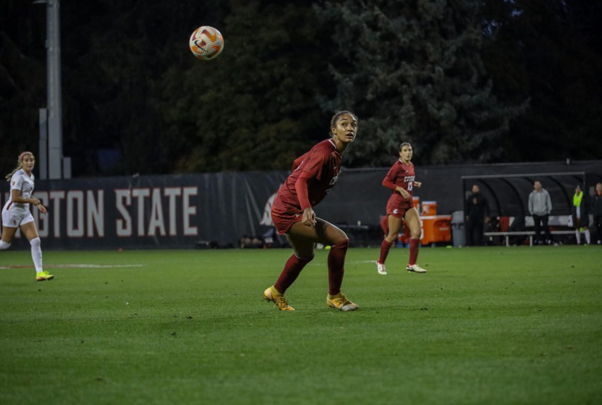 WSU number 14, forward Margie Detrizo, gazes at the ball suspended mid-air at an NCAA womens soccer game against USC, Sept. 28, 2023, in Pullman, Wash. 