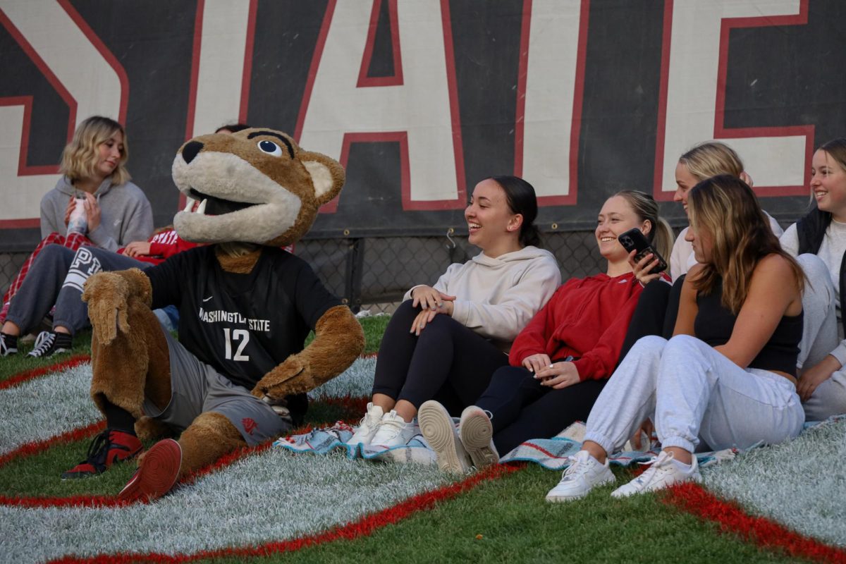 WSU mascot Butch T. Cougar watches the game progress alongside WSU students at an NCAA womens soccer game against USC, Sept. 28, 2023, in Pullman, Wash. 