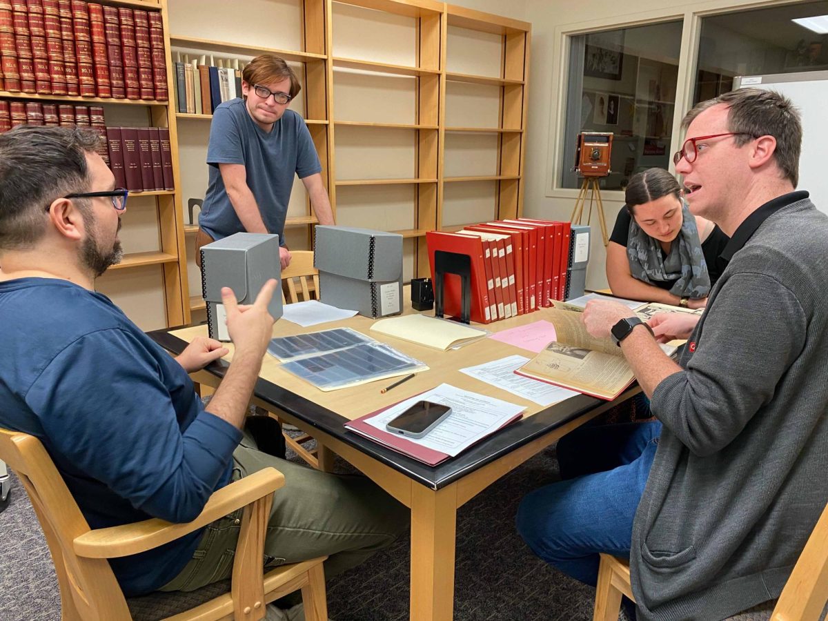 Drew Gamboa oversees the group looking through archival material alongside Matthew Jeffries, director of the LGBTQ+ center.