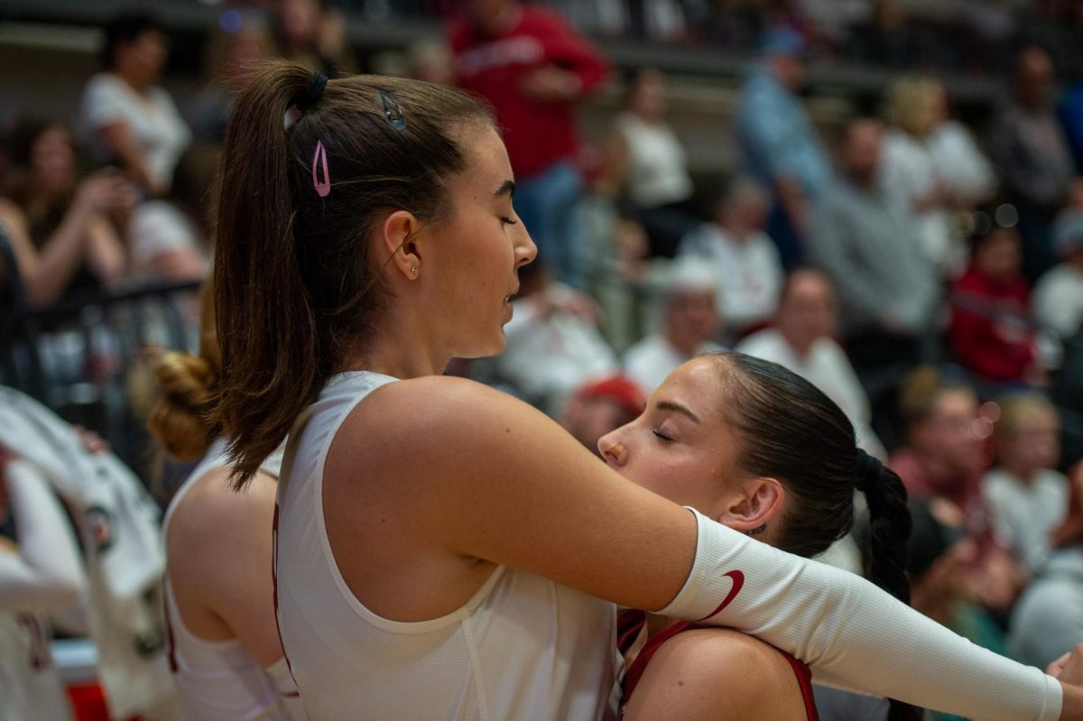 Katy Ryan and Karly Basham pregame of an NCAA volleyball match against Utah, Oct. 13, in Pullman, Wash. 