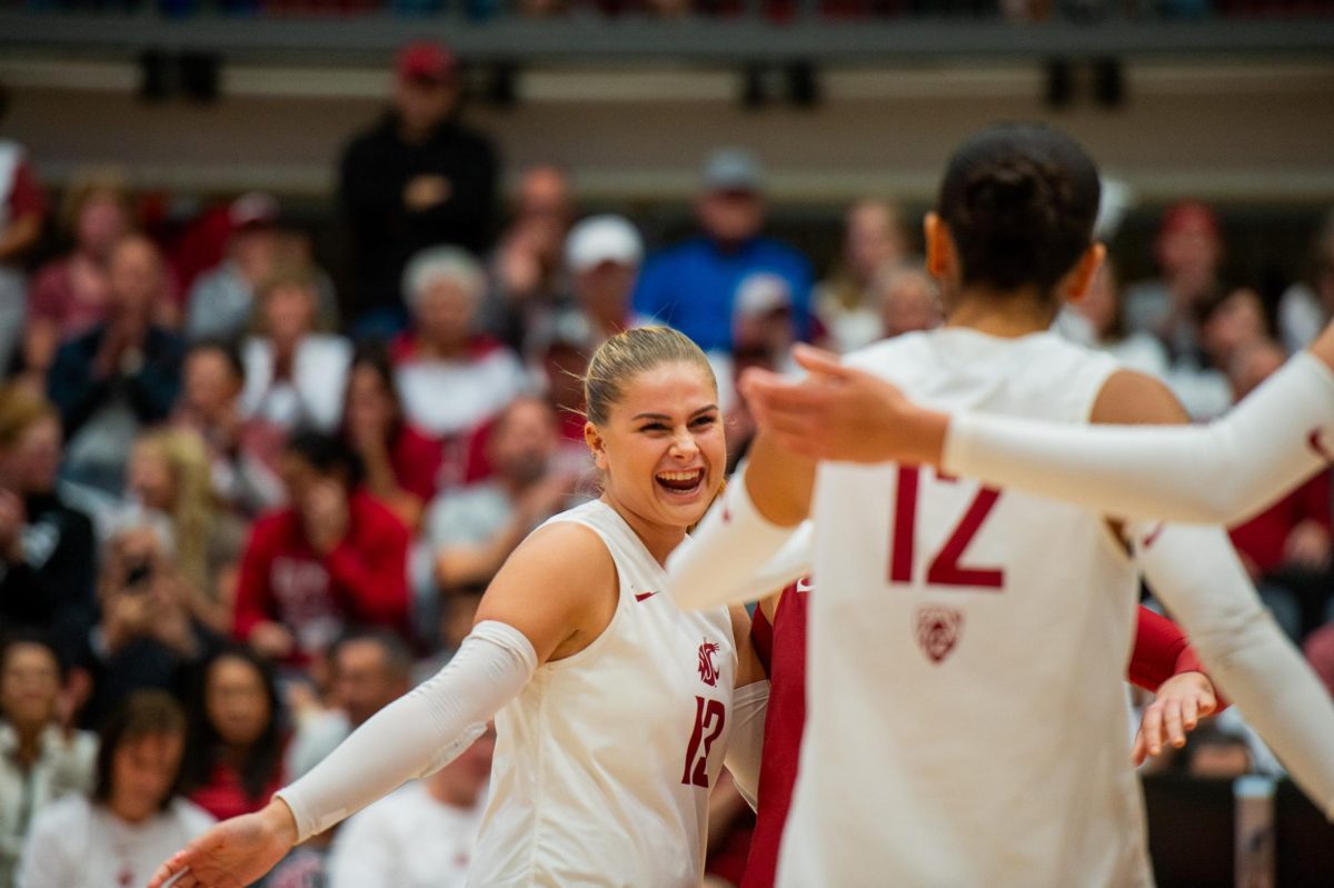 Emma Barbero smiles toward Argentina Ung after winning a point, Oct. 13, in Pullman, Wash.