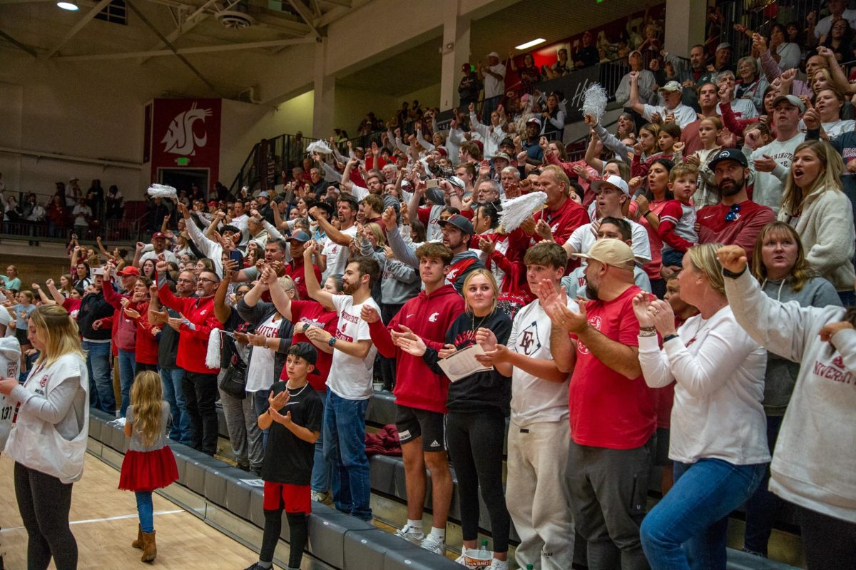 WSU fans singing the WSU Fight Song after a volleyball win, Oct. 13, in Pullman, Wash. 