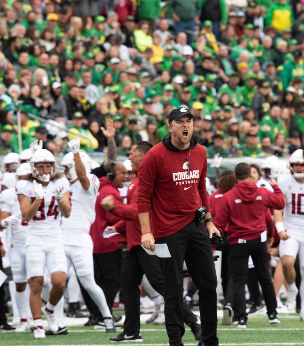 WSU offensive coordinator Ben Arbuckle celebrates WSU's first touchdown of the game against the Oregon Ducks, Oct. 21, 2023 at Autzen Stadium Eugene, Oregon.