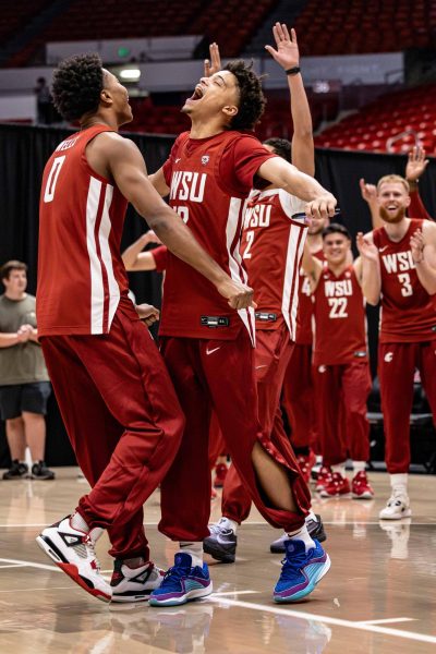 WSU forward Jaylen Wells and guard Isiah Watts celebrate after winning a game of bump during ZzuMania, Nov. 3, 2023, in Pullman, Wash.
