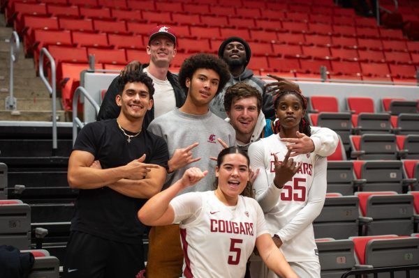 Bella Murekatete and Charlisse Leger-Walker pose with fans after the Cougs season-opening win, Nov. 6, in Pullman, Wash.  