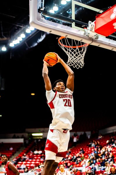 Rueben Chinyelu skies through the air for a dunk during the first half of the Cougs 82-72 win over EWU, Nov. 27, in Pullman, Wash. 