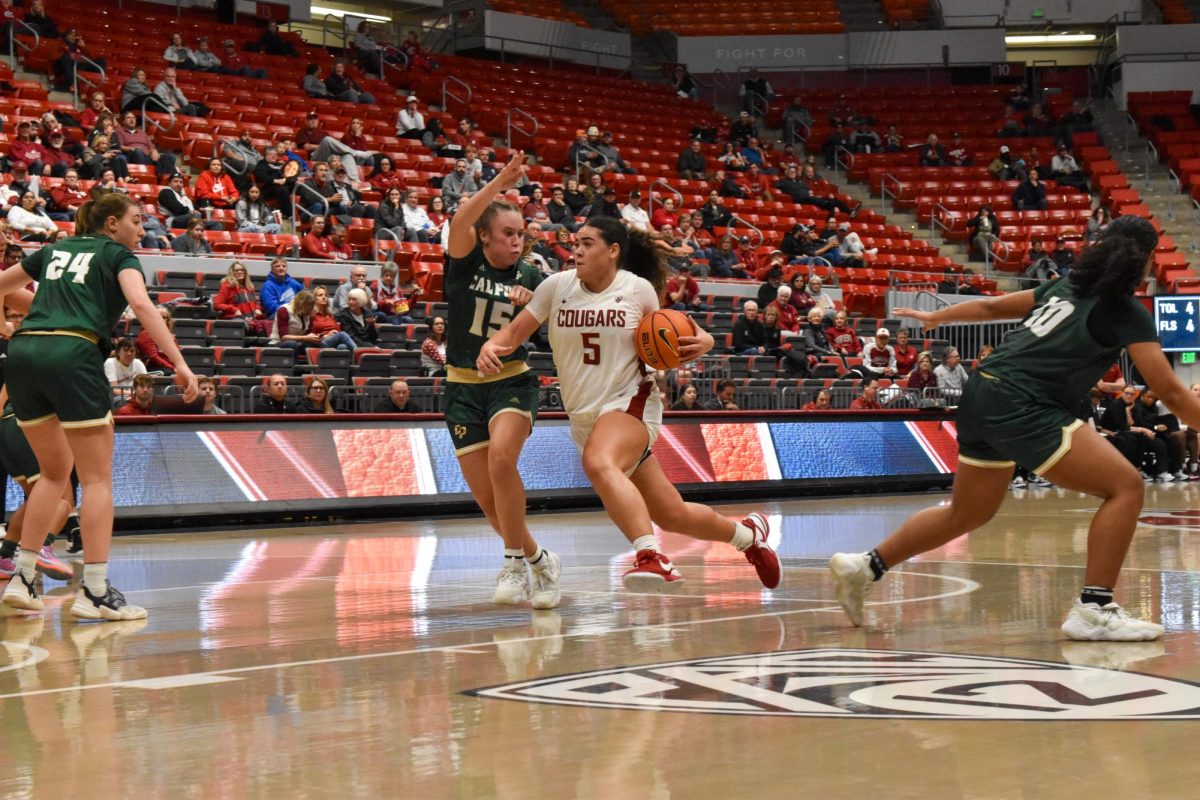 WSU Guard Charlisse Leger-Walker dribbles the ball down the court while Cal Polys guard Sydney Bourland closely follows at the NCAA womens basketball game, Nov 6th, 2023.