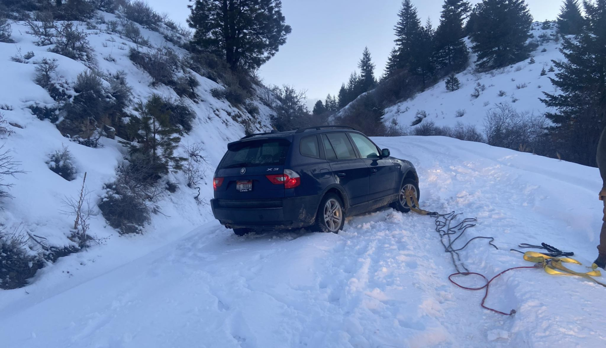 Car stuck on snowy hill getting help from  Justin Wildmans business 541 Roadside. 