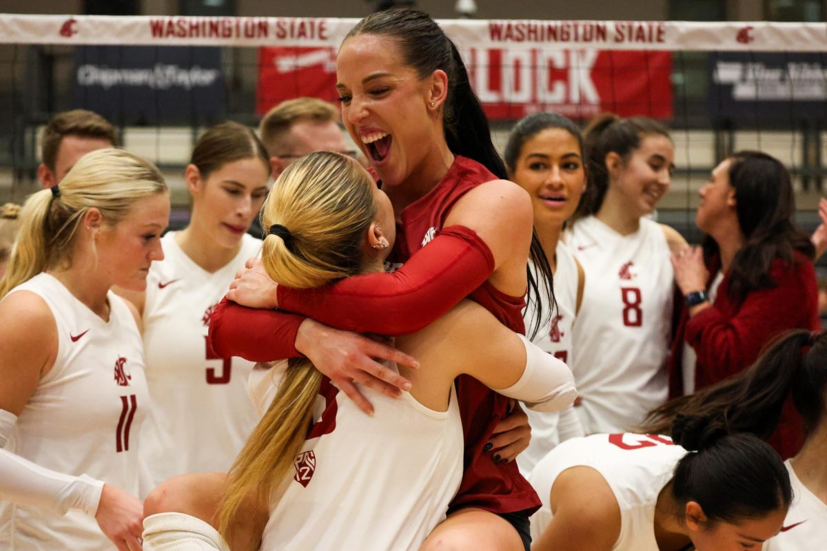 Karly Basham hugs Emma Barbero after defeating USC in a five-set match, Nov. 12, in Pullman, Wash.