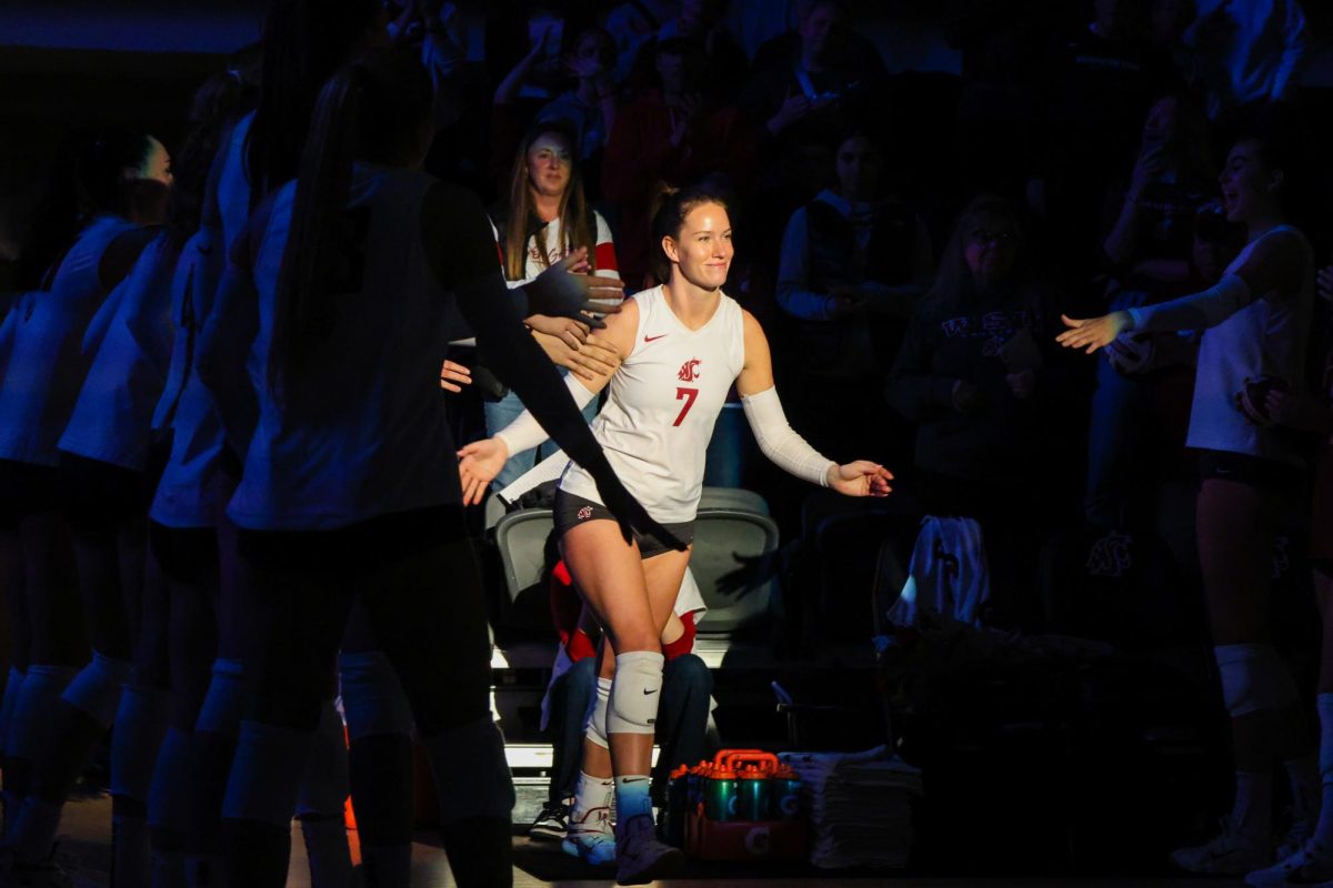 Starter Pia Timmer runs onto the court while high-fiving teammates, Nov. 12, in Pullman, Wash.