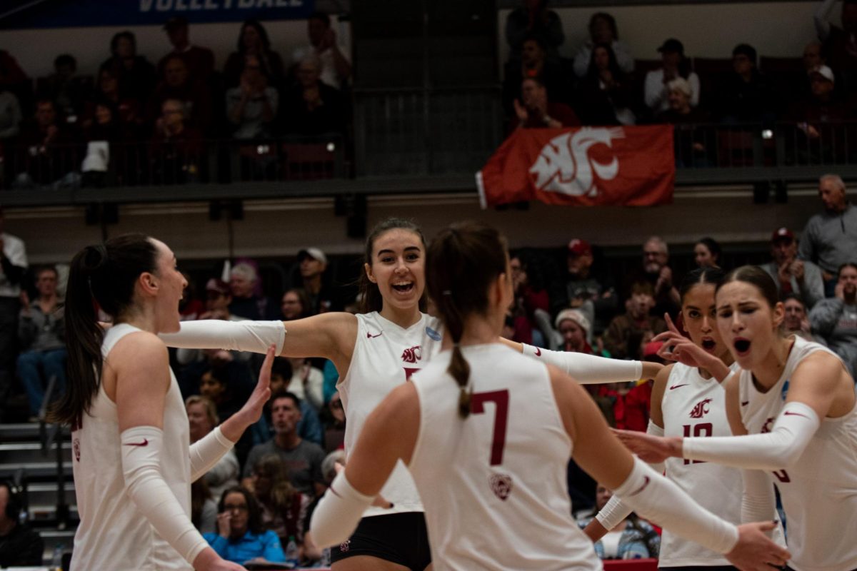 Lana Radakovic, Katy Ryan, Argentina Ung and Iman Isanovic celebrate Pia Timmer after WSU volleyballs big play in round two of the NCAA Tournament vs. Dayton Dec. 2 in Pullman, Wash.