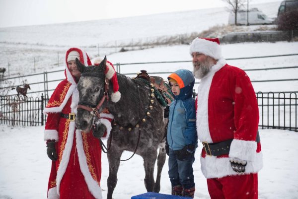 Mr. and Mrs. Claus arrive at the Appaloosa Museum in Moscow to greet families for the holidays.