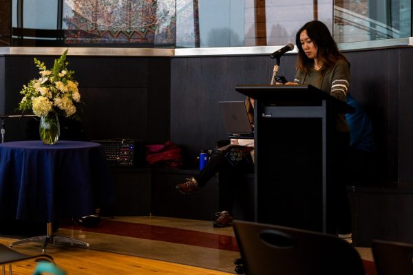 Senior Brittney Nguyen reads one of two poems during a celebration of life and remembrance for companion animals, Jan. 6, in Pullman, Wash.