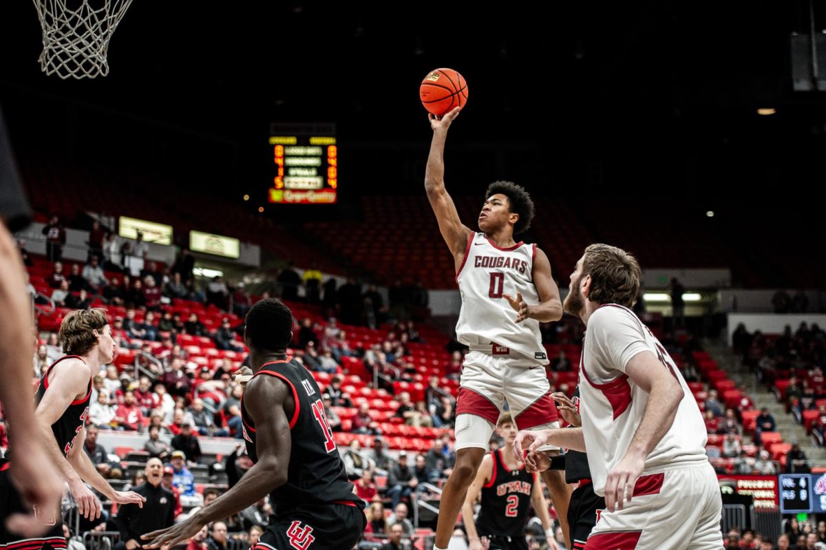 Jaylen Wells hangs in the air as he shoots the ball with just one hand, Jan. 24 2024, in Pullman, Wash. 