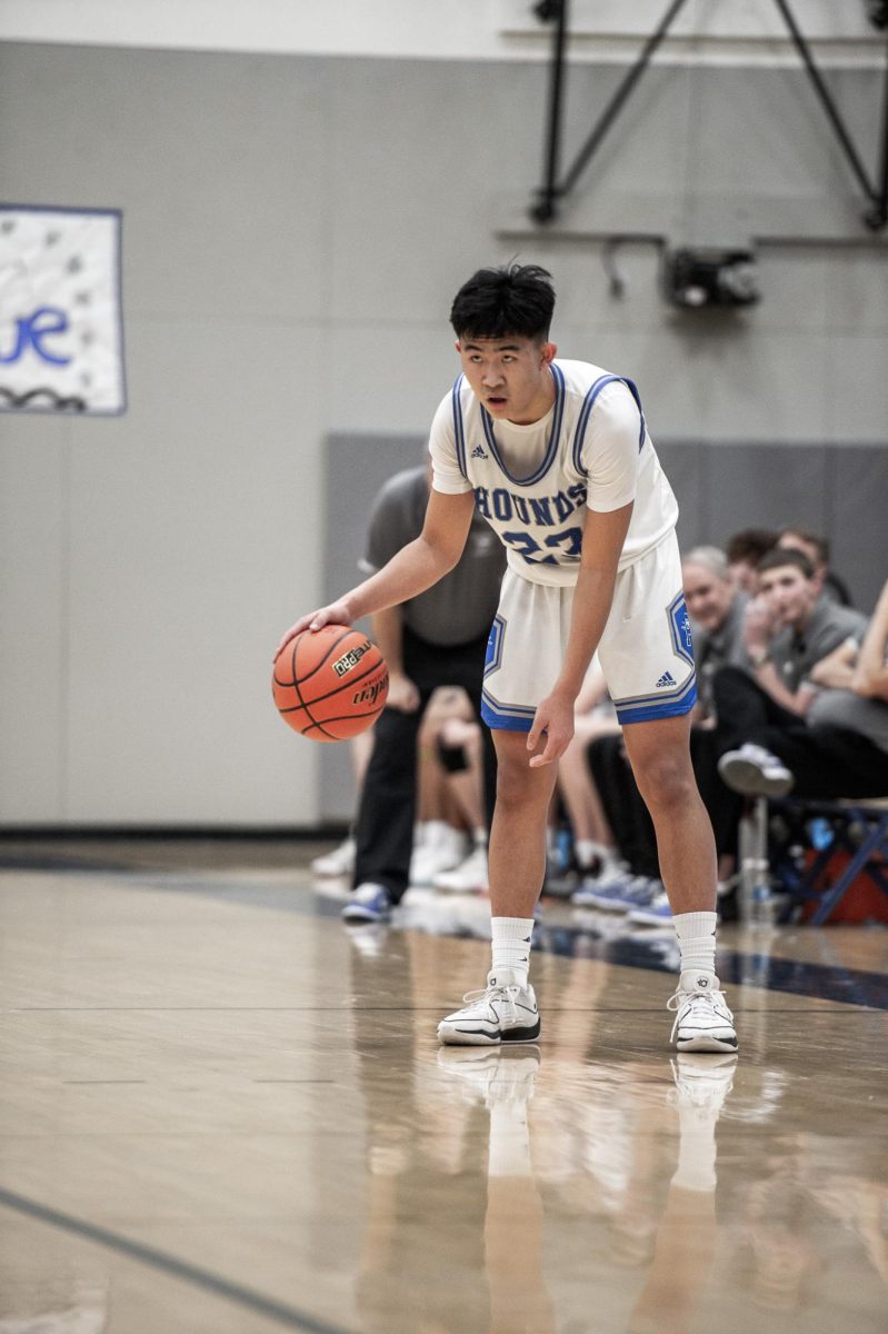 Daniel Kwon sizes up the defense in the closing seconds of the first quarter of a high school basketball game, Jan. 25, in Pullman, Wash. 