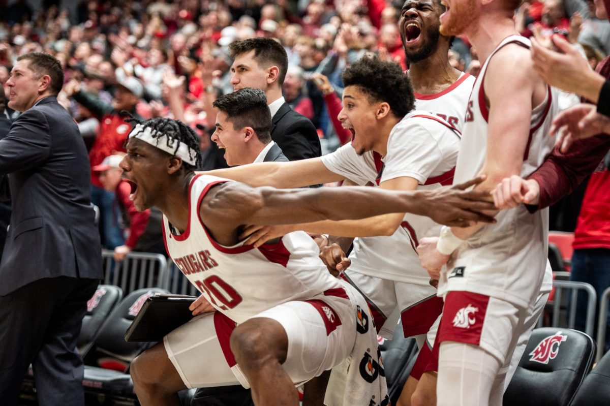 Rueben Chinyelu and the WSU bench emphatically celebrate a huge Cougs bucket, Jan. 27, in Pullman, Wash.Jan. 27, 2024 in Pullman, Wash.
