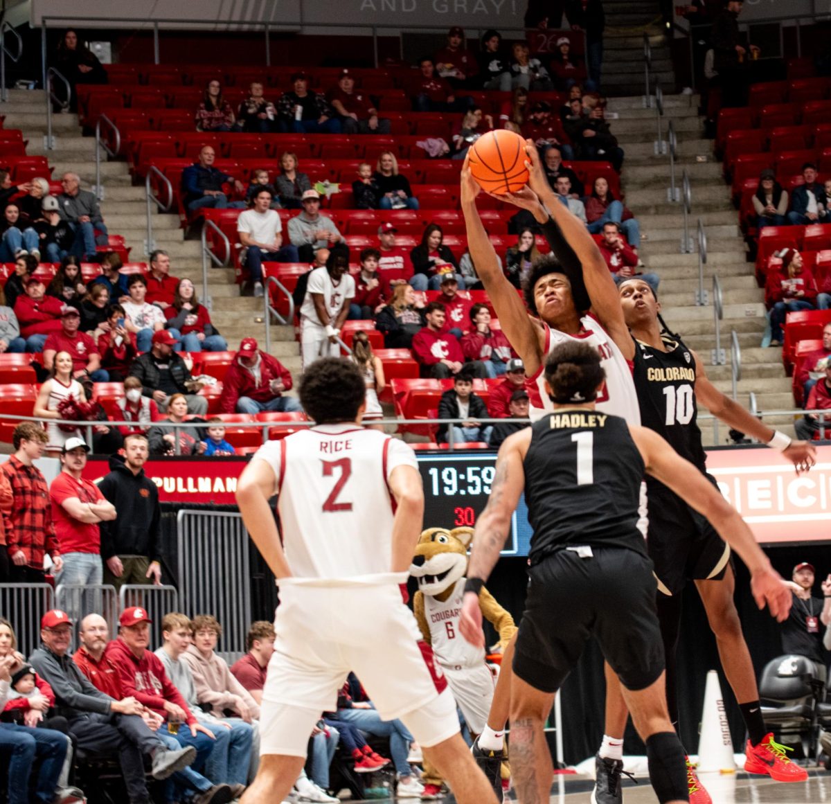 WSU forward Jaylen Wells leaps for the ball as guard Myles Rice looks on during WSU mens basketballs 78-69 win over Colorado, Jan. 27 in Pullman, Wash. 