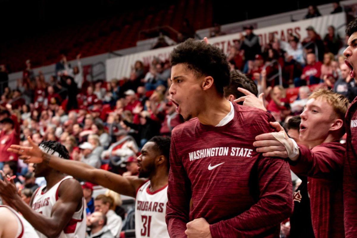 Isaiah Watts, Parker Gerrits, Kymany Houinsou and members of the WSU bench celebrate a Cougar basket during WSU mens basketballs 78-69 win over Colorado, Jan. 27 in Pullman, Wash. 
