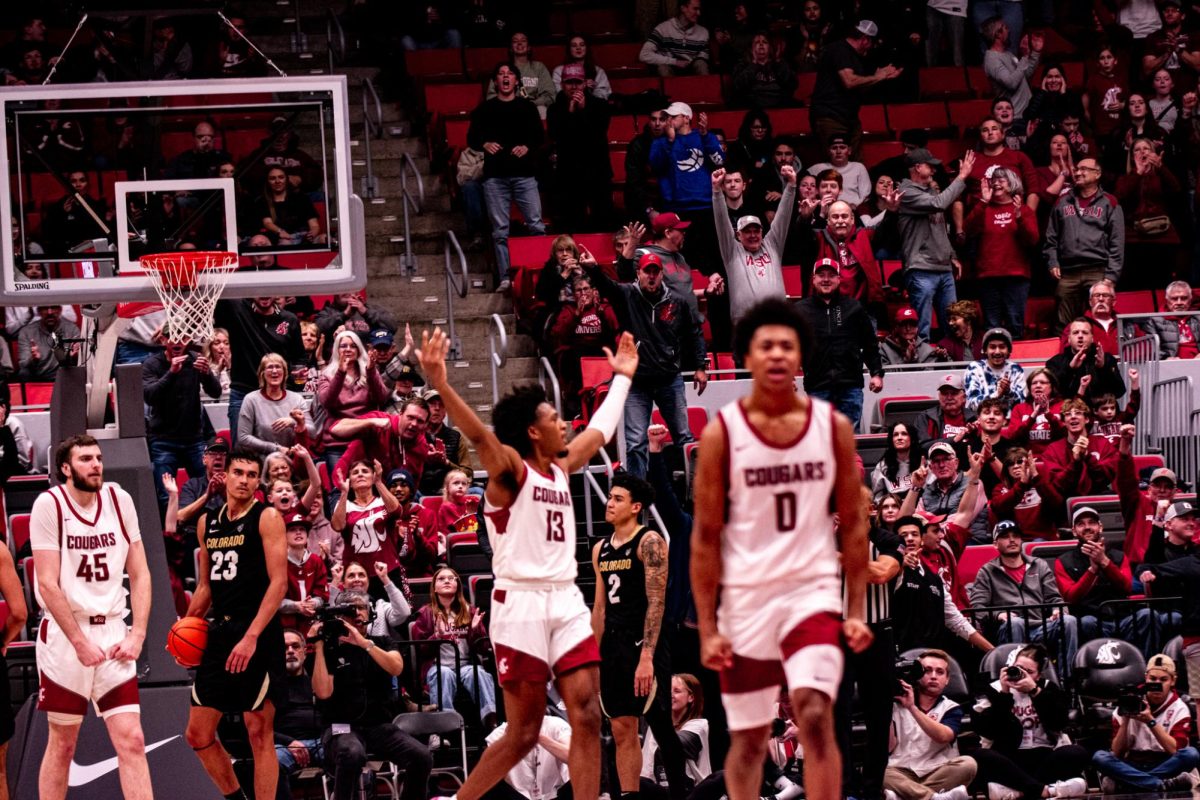 Isaac Jones hypes up the crowd as Jaylen Wells and Oscar Cluff walk away after WSU scored in the final minute of WSU mens basketballs 78-69 win over Colorado, Jan. 27 in Pullman, Wash. 