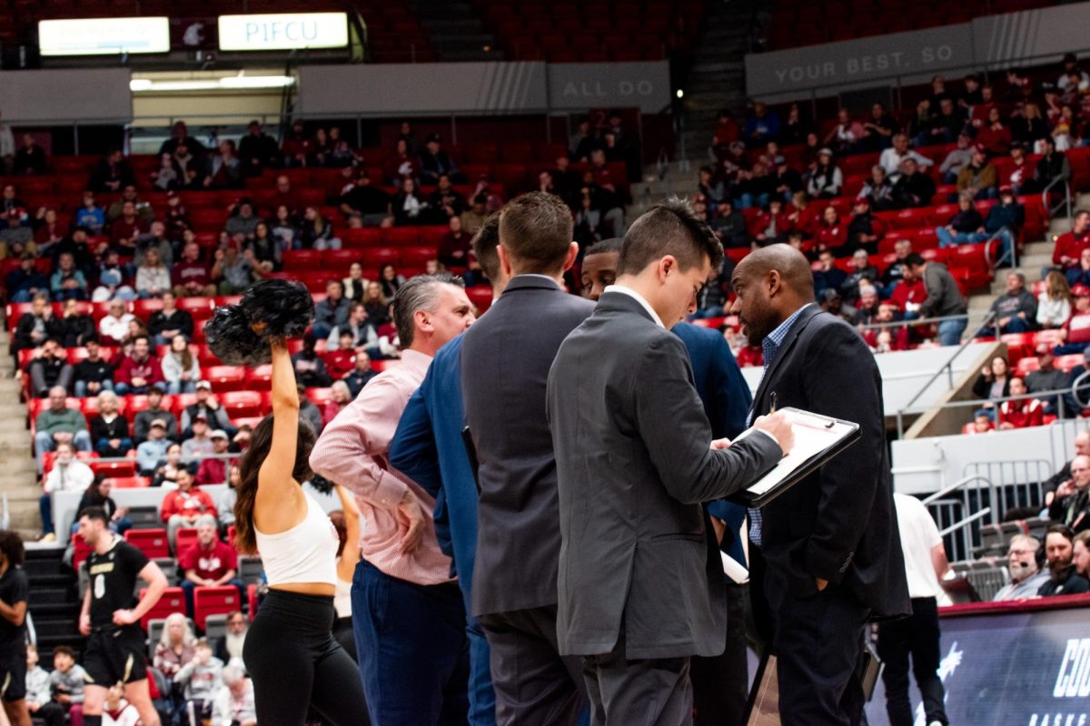 Kyle Smith meets with his coaching staff during WSU mens basketballs 78-69 win over Colorado, Jan. 27 in Pullman, Wash. 