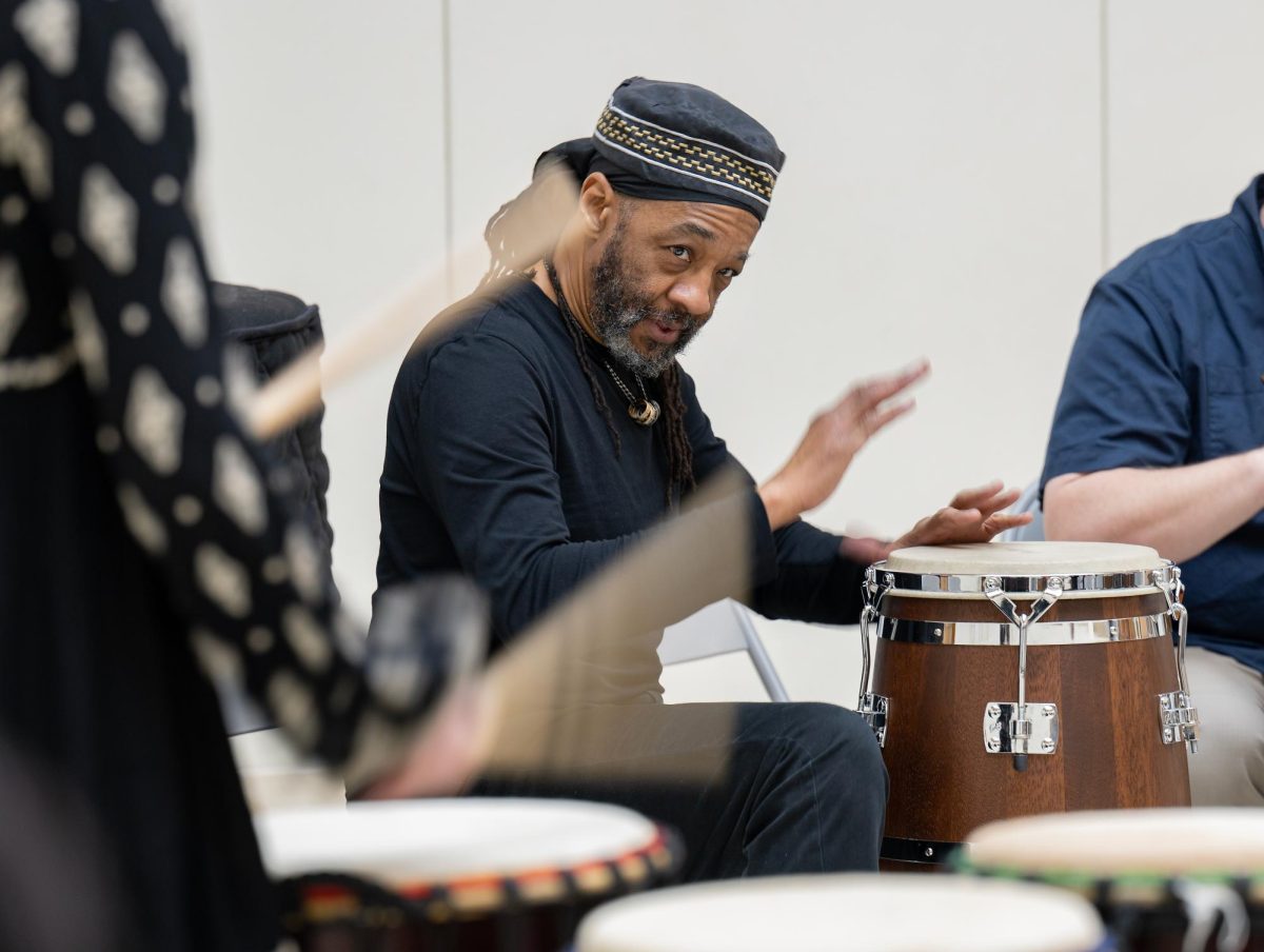 Doc D facilitates a drum circle in the Terrell Library Auditorium during the inaugural National Day of racial Healing event at WSU in 2023.