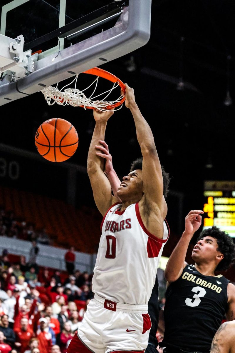 Forward Jaylen Wells dunks the ball with a scream during an NCAA men’s basketball game against Colorado, Jan. 27, 2024, in Pullman, Wash.