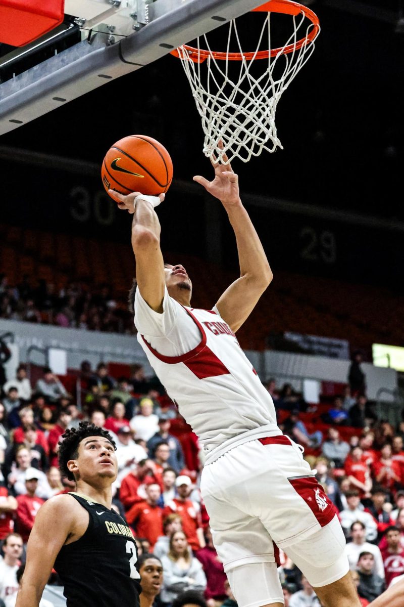 Guard Myles Rice jumps to put the ball into the hoop during an NCAA men’s basketball game against Colorado, Jan. 27, 2024, in Pullman, Wash.
