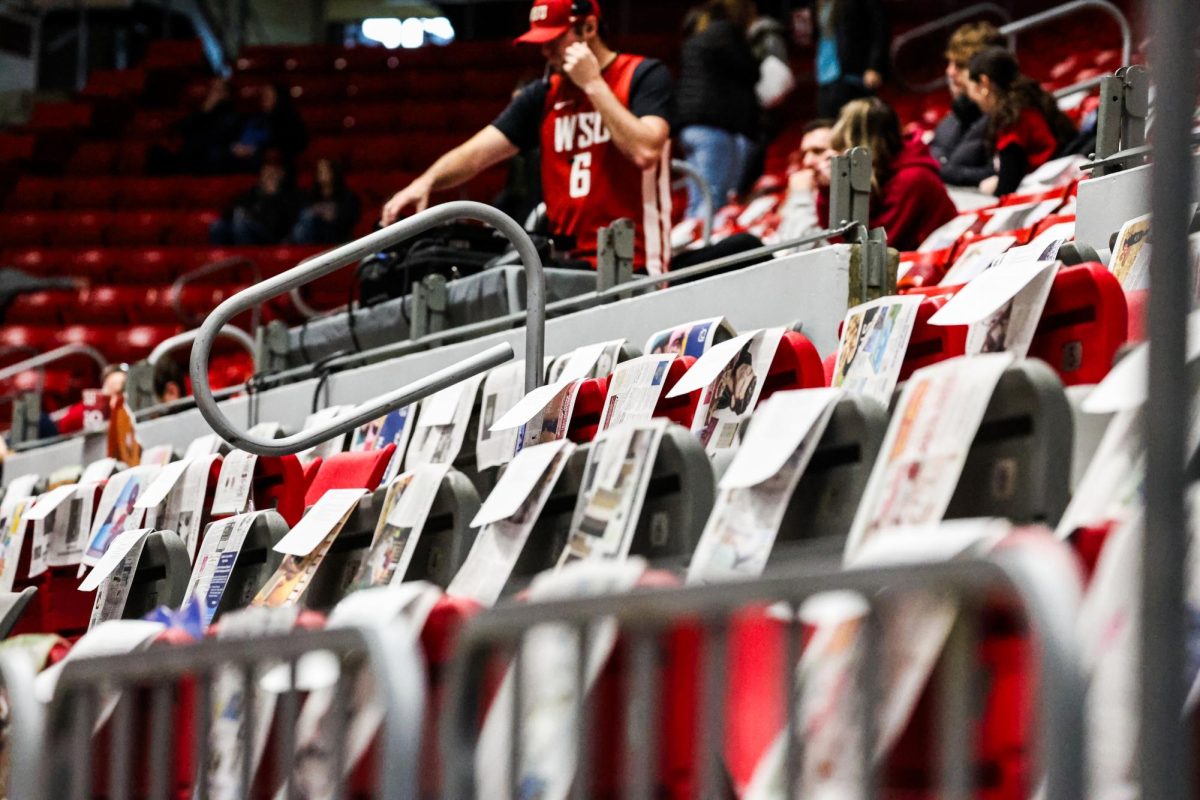 The front of the student section in Beasley Coliseum is covered with newspapers for students to pose with before an NCAA men’s basketball game against Colorado, Jan. 27, 2024, in Pullman, Wash.