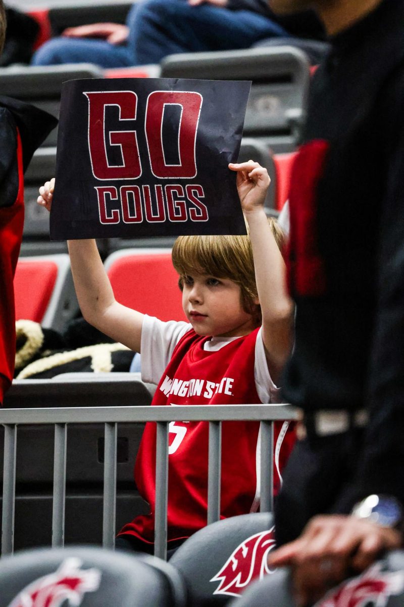 A young fan holds up a supportive sign for the WSU men’s basketball team during an NCAA mens basketball game against Utah, Jan. 24, 2024, in Pullman, Wash. 
