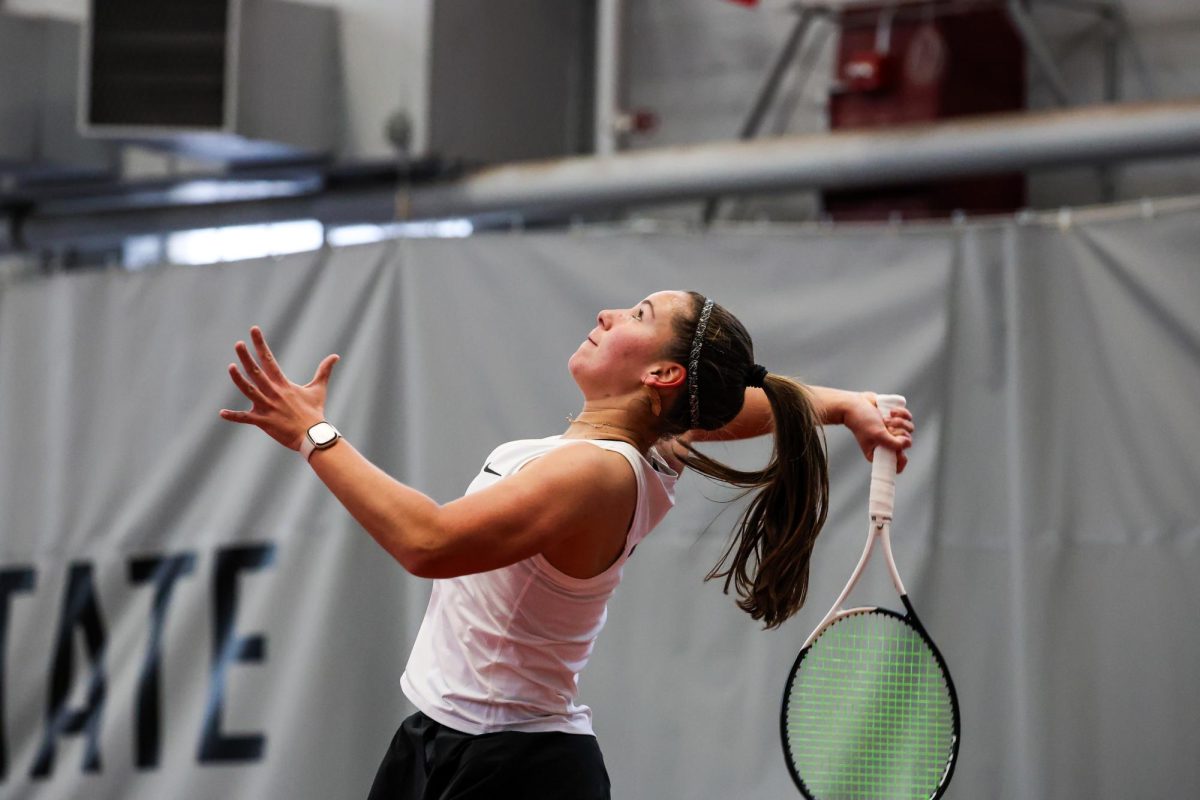 WSU tennis player Eva Alvarez Sande winds up to serve the ball during an NCAA tennis match against Eastern Washington, Jan. 20, 2024, in Pullman, Wash.