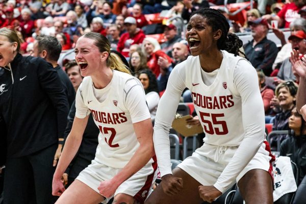 WSU guard Kyra Gardner and center Bella Murekatete flex in celebration on the sidelines during an NCAA womens basketball game against Arizona, Jan. 21, 2024, in Pullman, Wash.