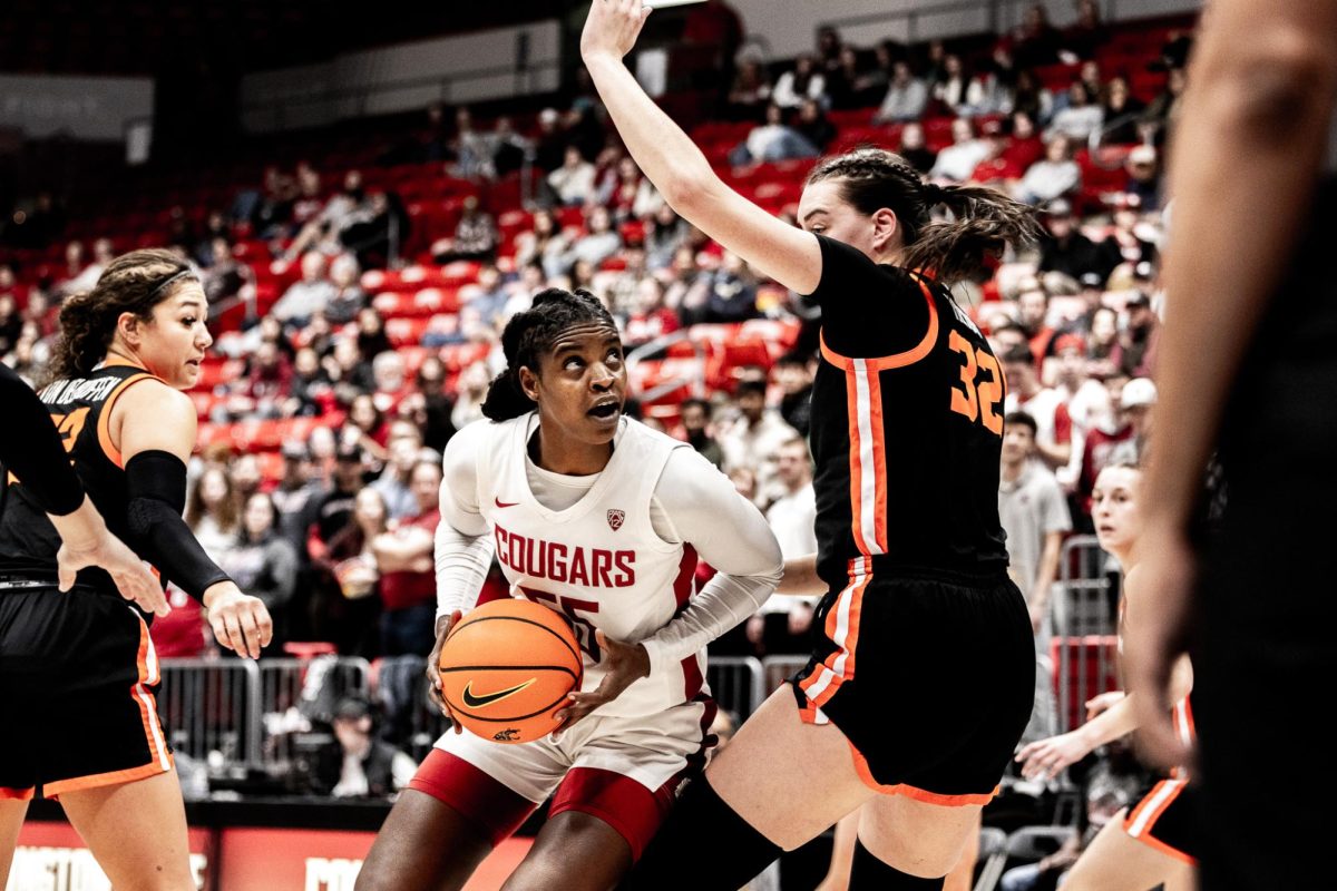 Bella Murekatete lowers her shoulder after contact and before rising up for a shot attempt against Oregon State, Feb. 23, in Pullman, Wash. 