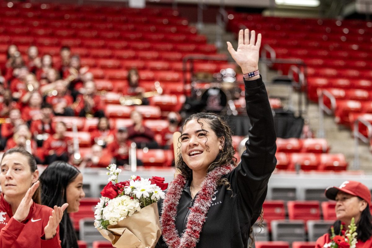 Charlisse Leger-Walker waves to the crowd during senior night, Feb. 25, in Pullman, Wash.