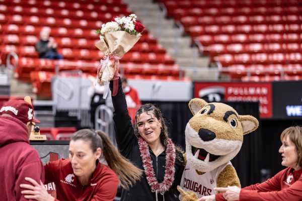 WSU guard Charlisse Leger-Walker receives a standing ovation from cougar fans during senior night recognitions, Feb. 25, 2024, in Pullman, Wash.