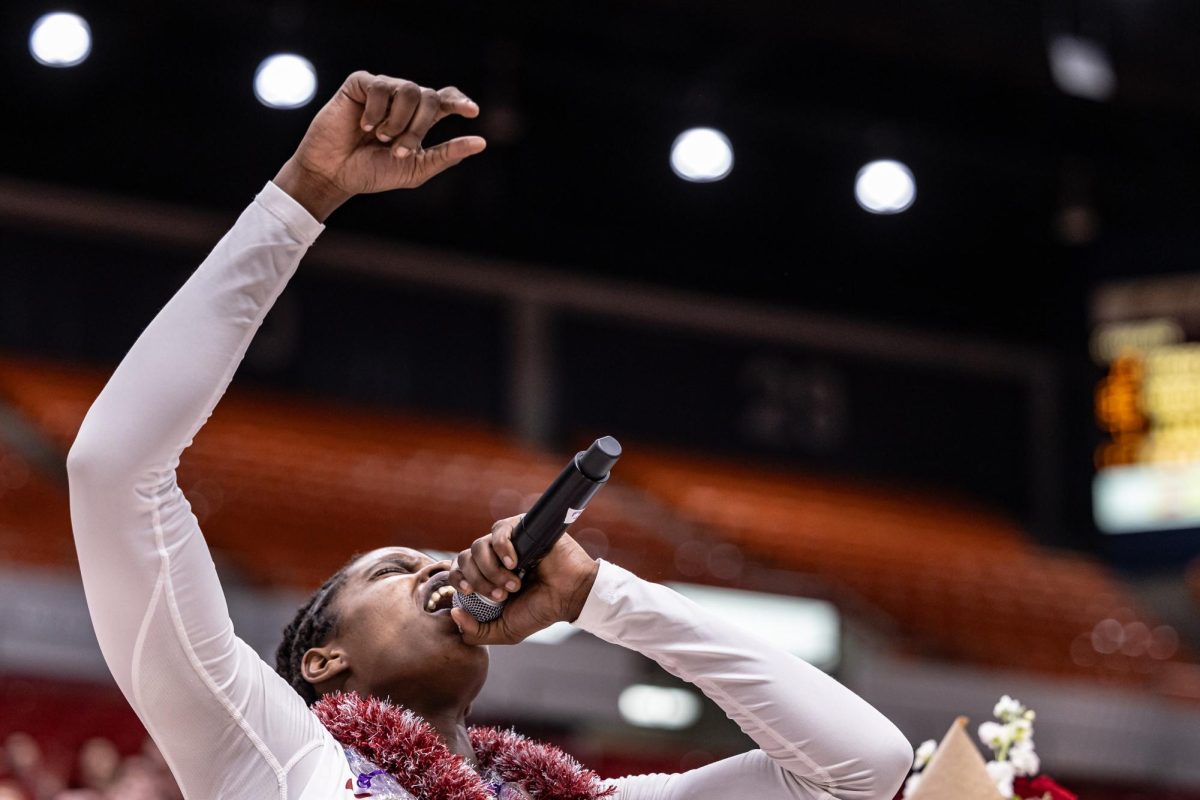 WSU center Bella Murekatete leads the singing of the WSU fight song during senior night recognitions, Feb. 25, 2024, in Pullman, Wash.
