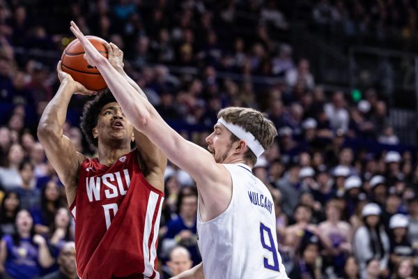 WSU forward Jaylen Wells jumps for a shot during an NCAA men’s basketball match against UW, Feb. 4, 2024, in Seattle.