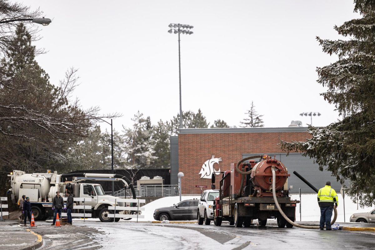 A vacuum truck begins to clean up a diesel spill along North Fairway Road next to Beasley Coliseum, Feb. 15, 2024, in Pullman, Wash.