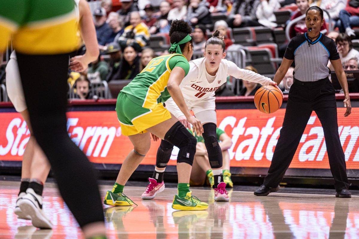 WSU guard Astera Tuhina dribbles the ball while waiting for a screen during an NCAA women’s basketball game against Oregon, Feb. 25, 2024, in Pullman, Wash.