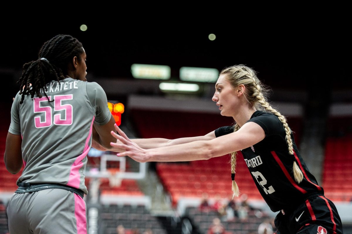 Cameron Brink fully extends her arm in defense against Bella Murekatete, Feb. 11, in Pullman, Wash.