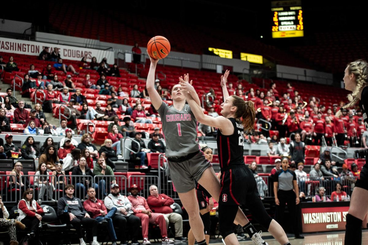 WSU guard Tara Wallack fights through contact on her left hand as she shoots with her right in the paint, Feb. 11, in Pullman, Wash.