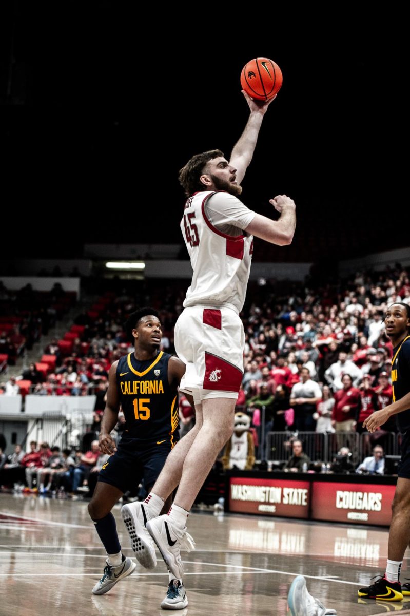 Oscar Cluff rises up and his defender flops to the ground, Feb. 15, in Pullman, Wash.
