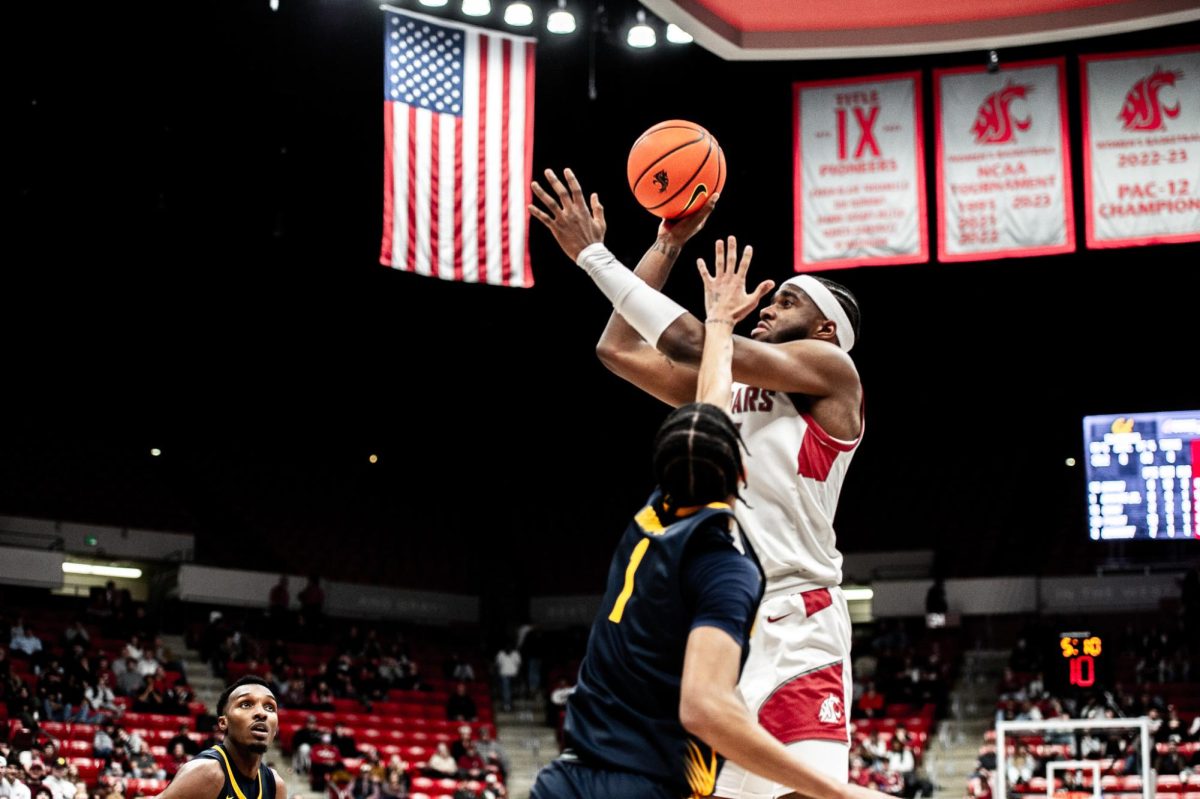 Kymany Houinsou shoots a floater from his right palm against Cal, Feb. 15, in Pullman, Wash.