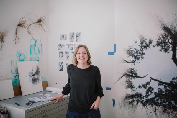 Kariann Fuqua posing at home in her bedroom turned studio.