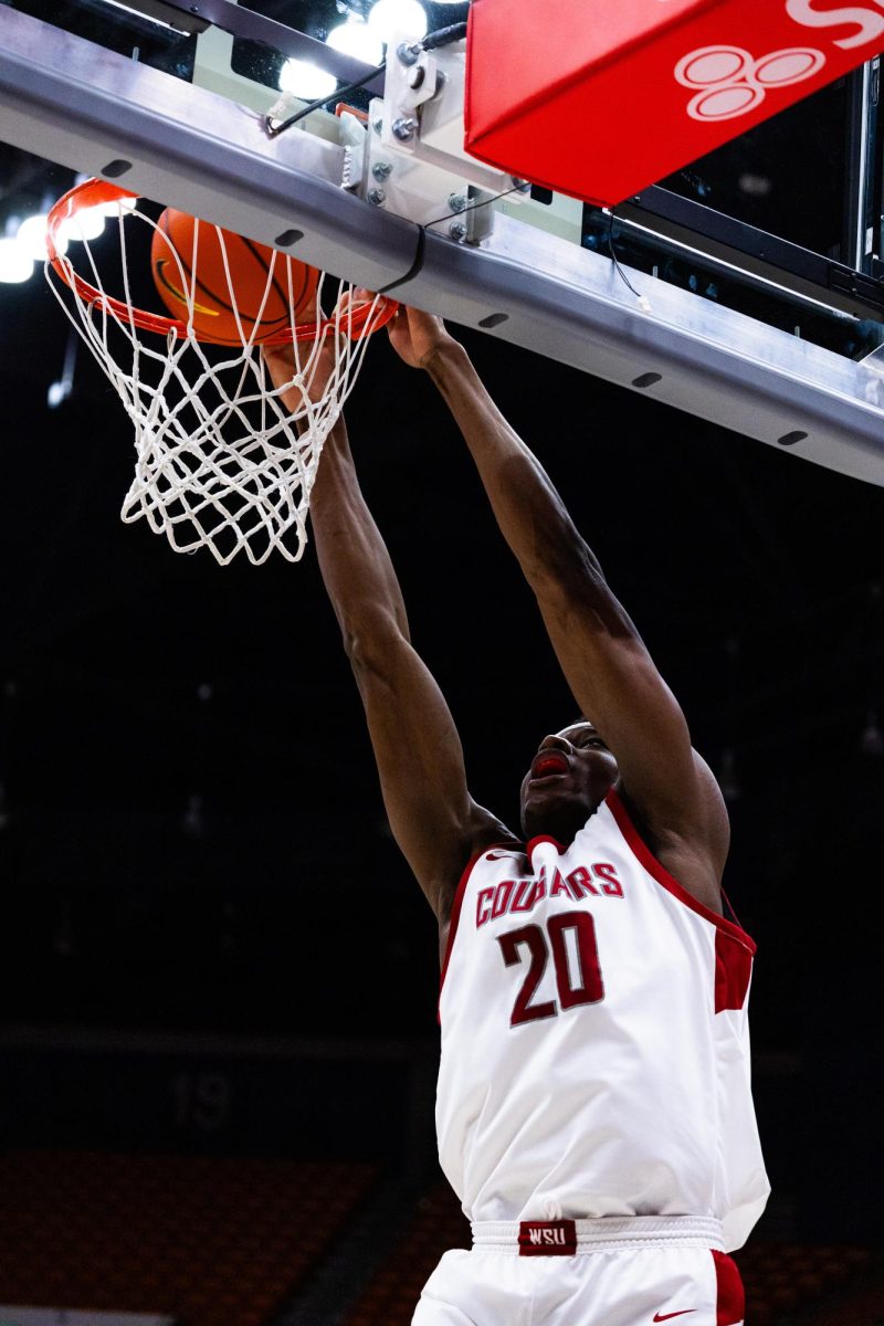 Center Rueben Chinyelu dunks the ball in an NCAA mens basketball game against Cal, Feb. 15, 2024, in Pullman, Wash. 