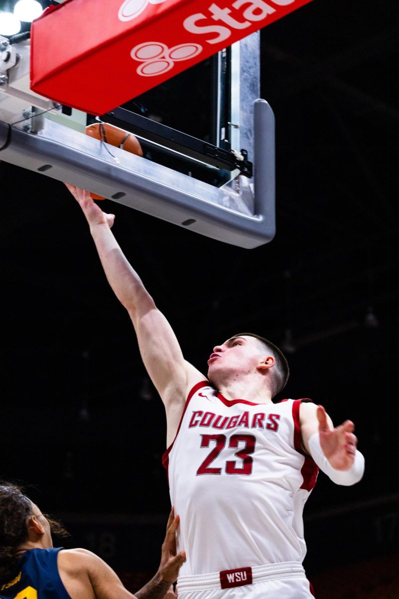 Forward Andrej Jakimovski leaps for a layup in an NCAA mens basketball game against Cal, Feb. 15, 2024, in Pullman, Wash.