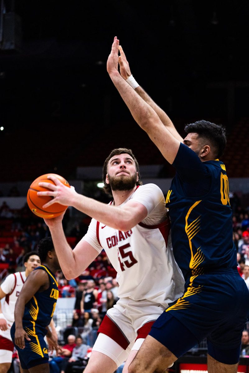 Center Oscar Cluff prepares to jump for a layup over a Cal defender during an NCAA mens basketball game, Feb. 15, 2024, in Pullman, Wash. 