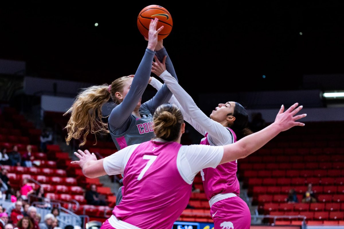 WSU guard Tara Wallack goes to shoot through two Cal defenders in an NCAA womens basketball game, Feb. 9, 2024, in Pullman, Wash.