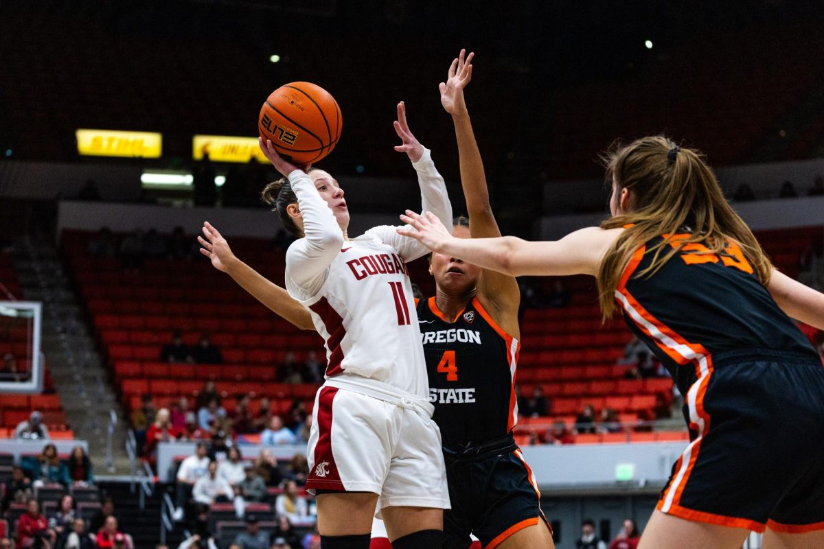 WSU guard Astera Tuhina prepares to shoot the ball in the face of Oregon State defenders during an NCAA womens basketball game, Feb. 23, 2024, in Pullman, Wash.