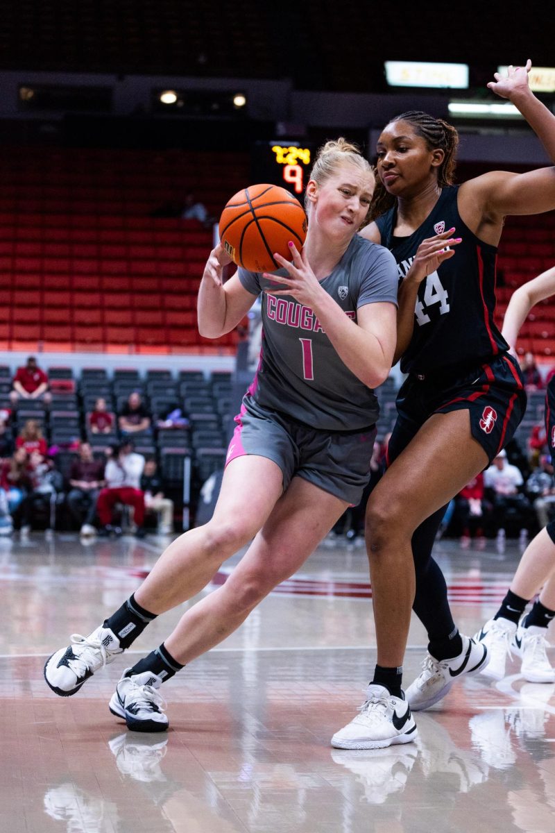 WSU guard Tara Wallack tries to drive to the hoop past a Stanford defender in an NCAA womens basketball game, Feb. 11, 2024, in Pullman, Wash.